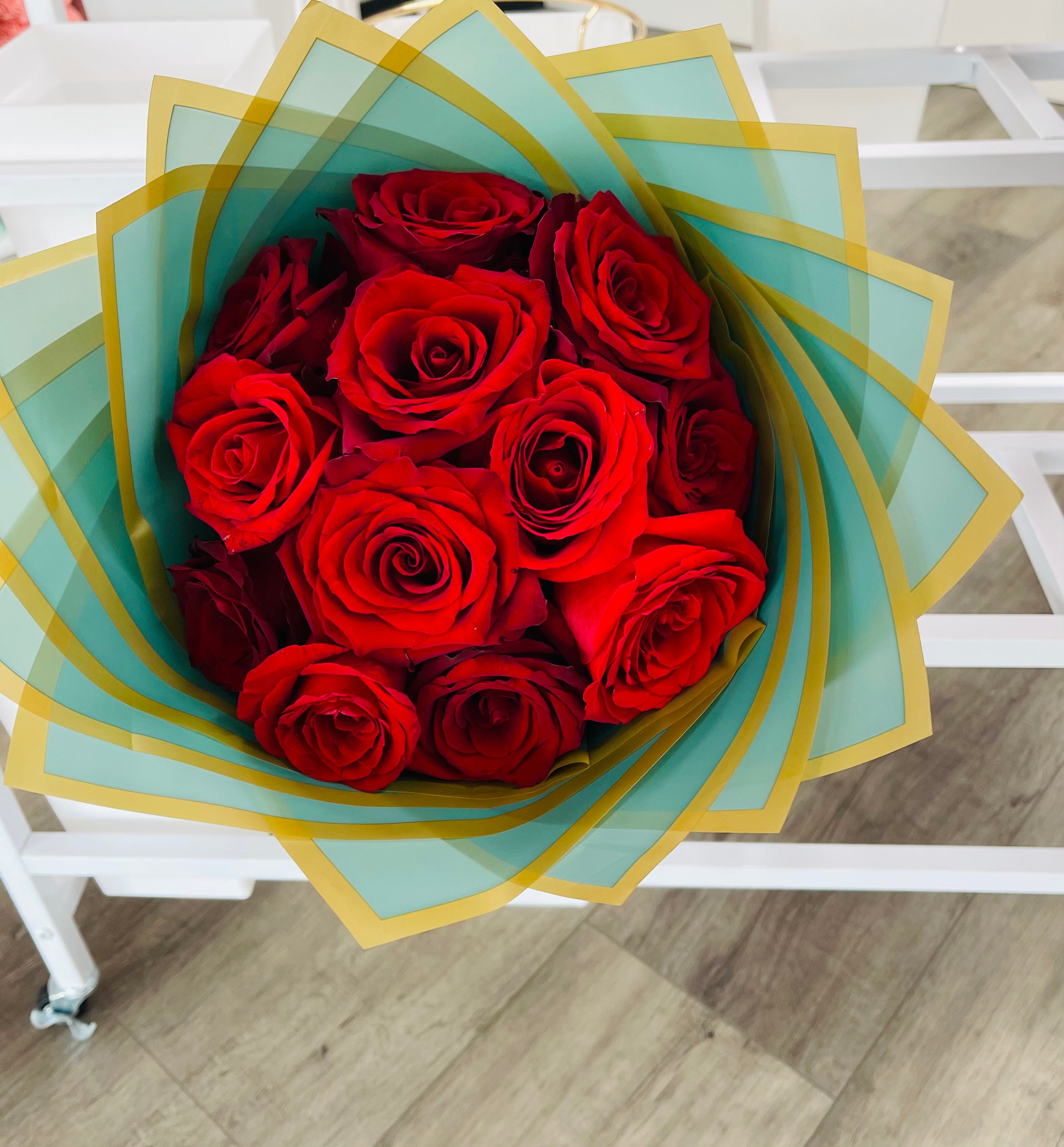 Dozen roses wrapped in green paper