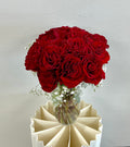 18 red roses in vase with baby breath